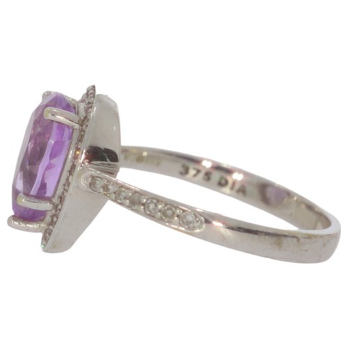 69 - 9ct white gold amethyst and diamond cluster ring. Set with one pear shape amethyst, and eight cut di... 