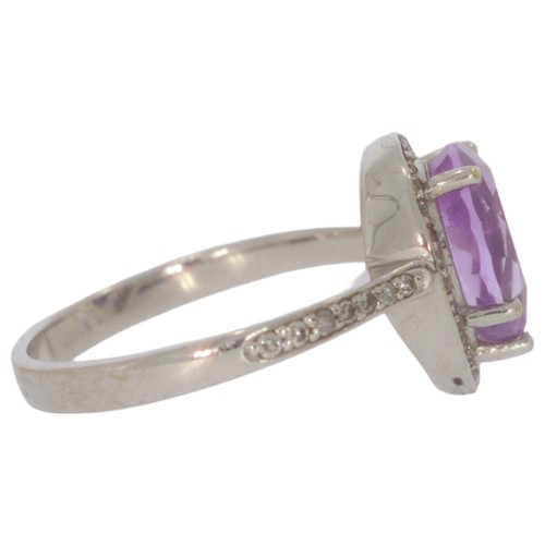 69 - 9ct white gold amethyst and diamond cluster ring. Set with one pear shape amethyst, and eight cut di... 