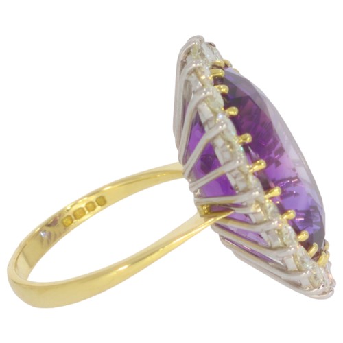 6 - 18ct gold amethyst and diamond cluster ring.Set with a vibrant violet amethyst measuring 20x14mm, an... 