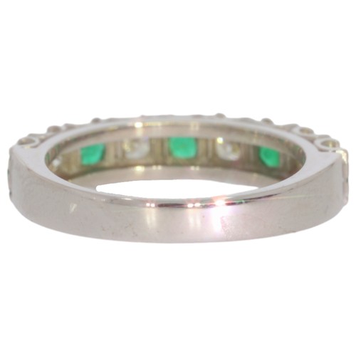 36 - 18ct white gold emerald and diamond half-eternity ring. Set with five vivid green emeralds, and bril... 