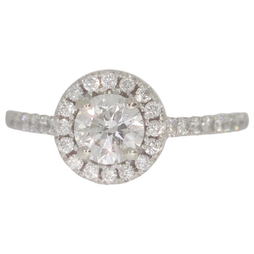 61 - Diamond halo cluster ring. Set with a principle brilliant cut diamond of 0.67ct calculated weight, a... 