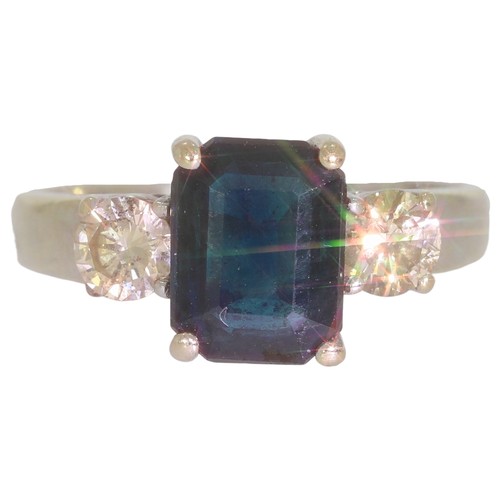 62 - Sapphire and diamond three stone ring.Set with an emerald cut sapphire, and brilliant cut diamonds o... 