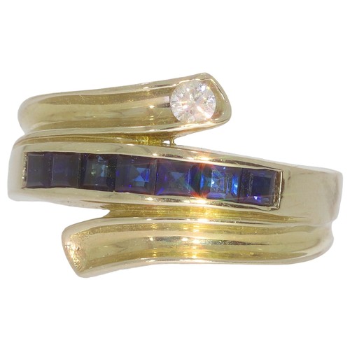 66 - Sapphire and diamond dress ring. Set with calibre cut sapphires, and a brilliant cut diamond of 0.08... 