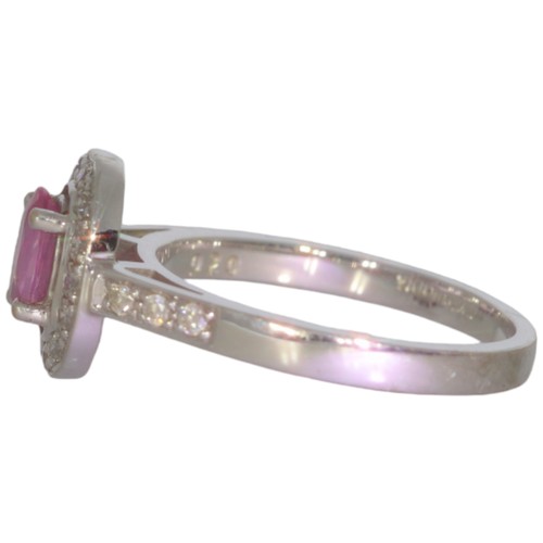 74 - 9ct white gold pink sapphire and diamond cluster ring. Set with an oval cut pink sapphire, and brill... 