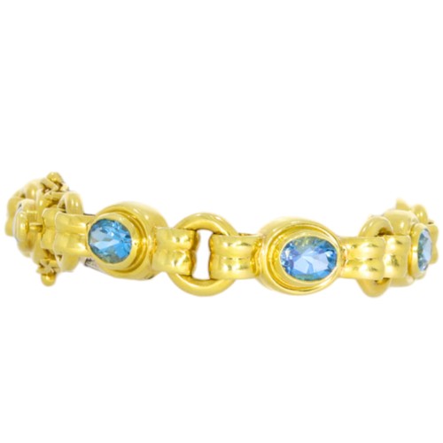 36 - 18ct yellow gold and blue stone bracelet.