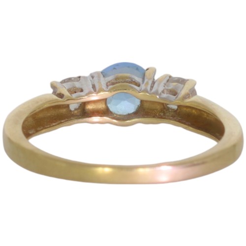 65 - 9ct gold topaz and CZ three stone ring. Set with an oval cut blue topaz, and CZ. Size M. Weight 2.2g... 