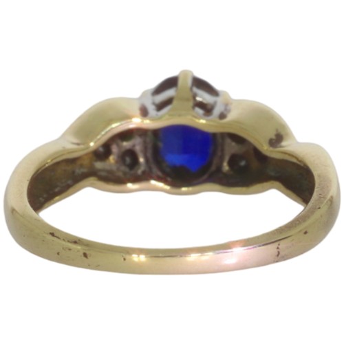 93 - A 9ct gold synthetic sapphire and diamond cluster ring. Set with an oval cut sapphire, and brilliant... 