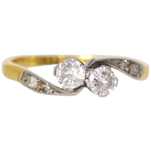 150 - 18ct yellow gold and platinum two-stone ring with diamond set shoulders. Set with a principle diamon... 