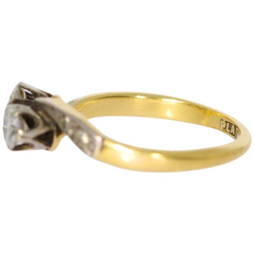 150 - 18ct yellow gold and platinum two-stone ring with diamond set shoulders. Set with a principle diamon... 