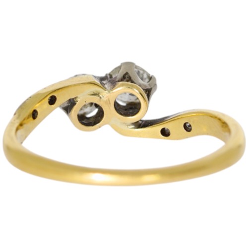 150 - 18ct yellow gold and platinum two-stone ring with diamond set shoulders. Set with a principle diamon... 