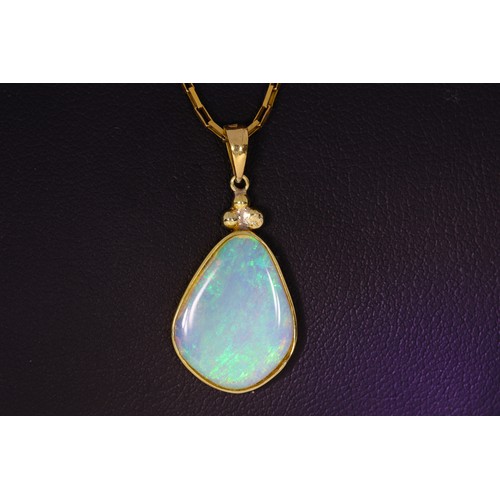 166 - 9ct gold opal pendant and chain. 4.8 Grams. Set with a 17.5 x 13.5mm crystal opal with good play of ... 