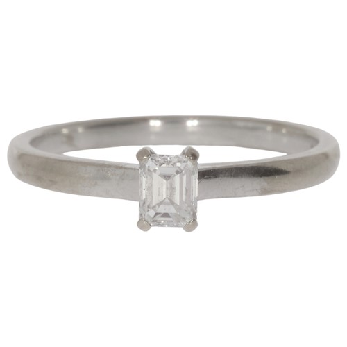 18ct white gold diamond single-stone ring. Set with a emerald cut diamond of 0.50ct calculated weight, assessed as E/F colour, VS clarity. Size S½. Weight 2.37g. Hallmarked Birmingham. Good, wearable condition.