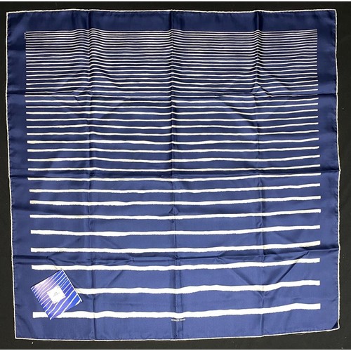 Hermès, Paris: "Mediterranee" Silk Twill Scarf, Designed by JLF Duviler (2003)A striking and elegant Hermès silk twill carré titled "Mediterranee," designed by JLF Duviler for the Spring-Summer 2003 collection. This classic design features crisp white horizontal stripes artfully set against a rich deep blue background, evoking the timeless allure of the sea. A versatile and iconic accessory, perfect for adding a touch of sophisticated Parisian chic to any ensemble. Appears to be in excellent, possibly unworn, condition with original tag.