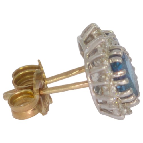 70 - 9ct gold topaz and diamond cluster earrings. Set with two oval blue topaz, and brilliant cut diamond... 