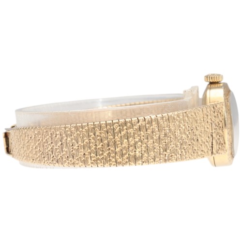 30 - A vintage ladies' 9ct gold Longines manual wind wristwatch, circa 1970. The cushion-shaped dial with... 