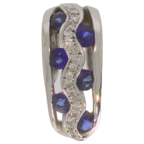 219 - A sapphire and diamond pendant With Missing Diamond.  Set with round sapphires and brilliant cut dia... 