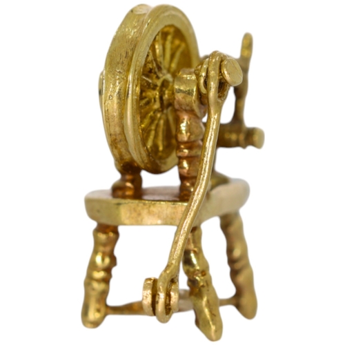 227 - 9ct spinning wheel charm. 2.7 Grams