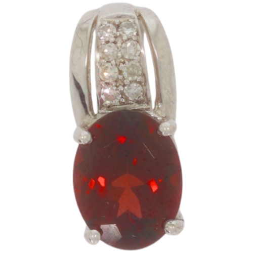 229 - 9ct white gold garnet and diamond pendant. Set with one oval garnet, and eight cut diamonds of appro... 