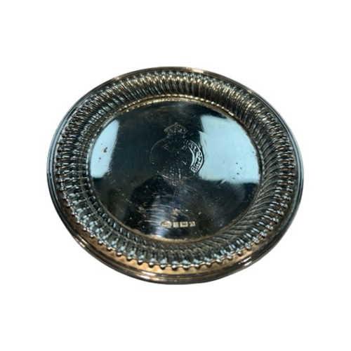 247 - A modern sterling silver drinks coaster, hallmarked Birmingham, 1998. The circular coaster features ... 