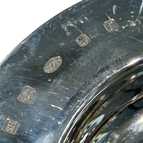 256 - A modern Elizabeth II sterling silver dish of circular form, featuring a broad rim and a deep, polis... 