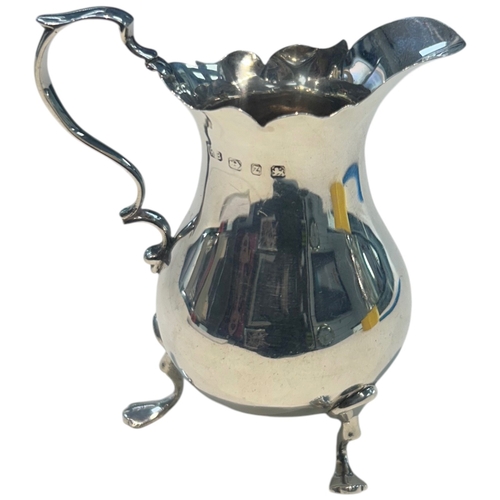 285 - A fine Late Victorian sterling silver cream jug of bulbous circular form, featuring a traditional 