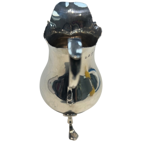 285 - A fine Late Victorian sterling silver cream jug of bulbous circular form, featuring a traditional 