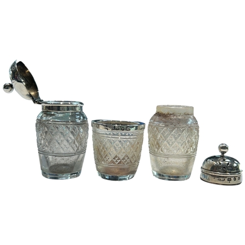 289 - A charming collection of three late Victorian and Edwardian silver-mounted glass vanity jars by the ... 