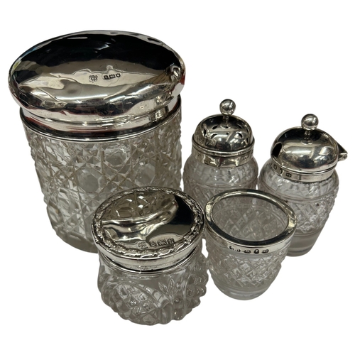 289 - A charming collection of three late Victorian and Edwardian silver-mounted glass vanity jars by the ... 
