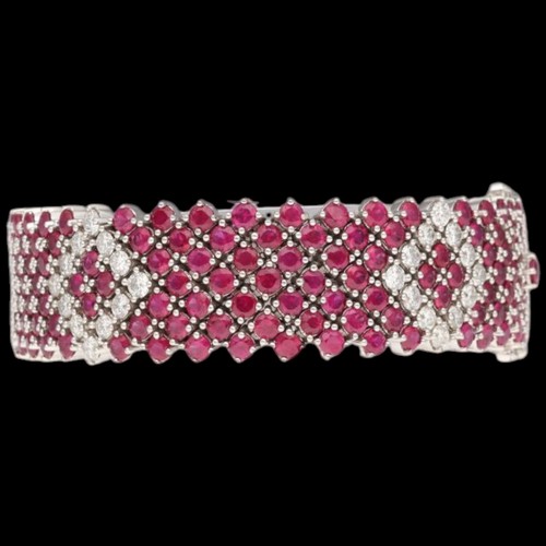 8 - An 18ct white gold ruby & diamond bracelet. Set with round rubies with a calculated total weight of ... 