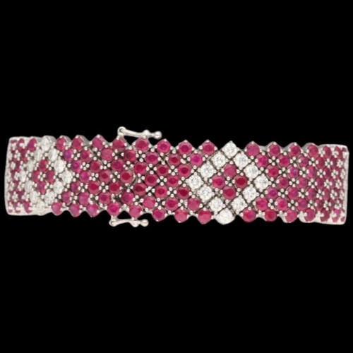 8 - An 18ct white gold ruby & diamond bracelet. Set with round rubies with a calculated total weight of ... 