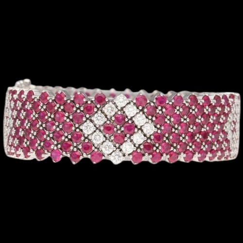 8 - An 18ct white gold ruby & diamond bracelet. Set with round rubies with a calculated total weight of ... 