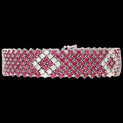 8 - An 18ct white gold ruby & diamond bracelet. Set with round rubies with a calculated total weight of ... 