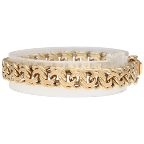 9 - A yellow metal stamped and tested 14k bracelet. Weighing 27.1g. Length: 8 inches.