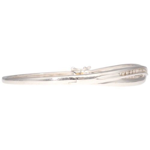 11 - 9CT White Gold Hinged Bangle Diamond. Set with eight cut diamonds of 0.50ct total estimated weight, ... 
