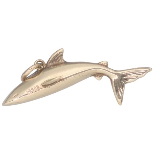 42 - A 9ct yellow gold shark charm. Weighing 0.97g.