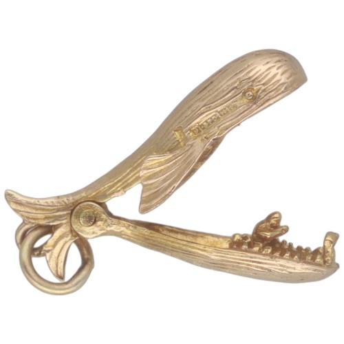 43 - A 9ct yellow gold whale charm with opening mouth with person inside. Weighing 2.3g.