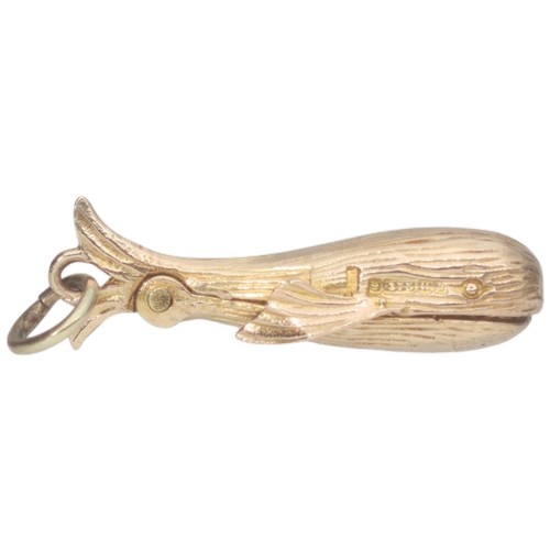 43 - A 9ct yellow gold whale charm with opening mouth with person inside. Weighing 2.3g.