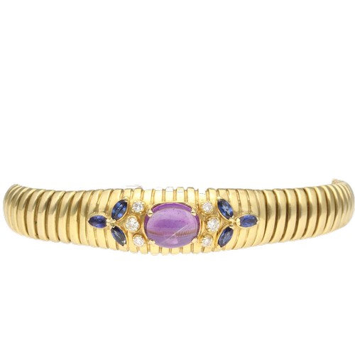5 - A yellow metal stamped and tested 750 amethyst, sapphire and diamond bracelet. Set with an oval cabo... 