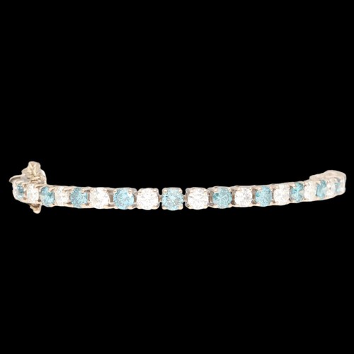 6 - White Metal Tested as 18ct Treated Blue Diamond And Diamond Tennis Bracelet. Set with treated blue b... 