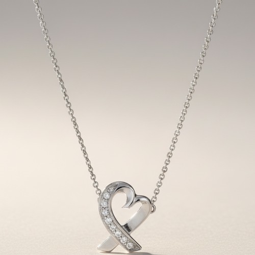 33 - 18ct white gold Tiffany diamond heart pendant and chain
Set with diamond accents
Chain length: 16 in... 