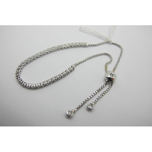 106 - A Modern 18ct White Gold Diamond Set Line Bracelet, claw set to the front with uniform brilliant cut... 