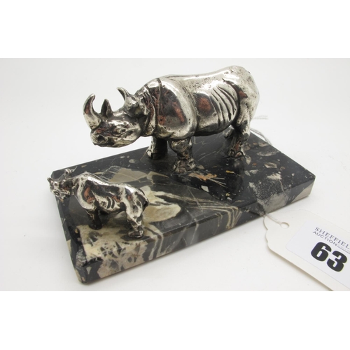 63 - An Art Deco Style Desk Paperweight, modelled with two rhinoceros, on mottled hardstone plinth base, ... 