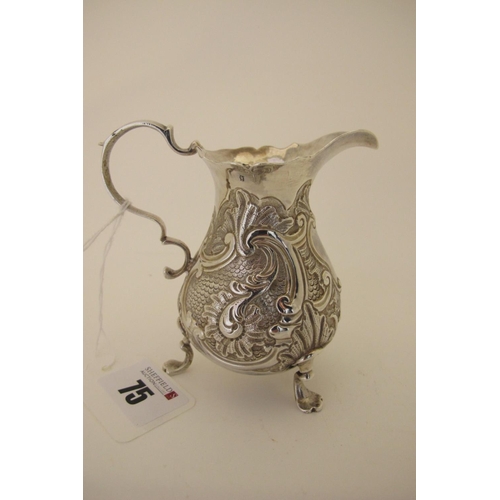 75 - A Hallmarked Silver Cream Jug, London 1744, of baluster form, allover detailed in relief with leaf s... 