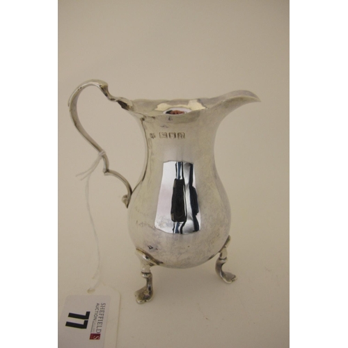 77 - A Hallmarked Silver Cream Jug, RP, London 1907, of plain baluster form with wavy edge and scroll han... 