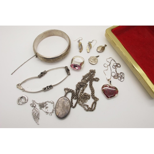 92 - A Hallmarked Silver Bangle, leaf scroll engraved to the front (dented), hinged to snap clasp (safety... 