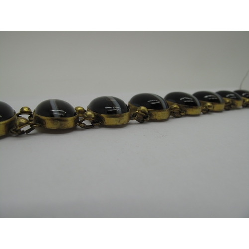 108 - A Victorian Gilt Metal and Hardstone Bracelet, of slightly graduated design, oval collet set (closed... 