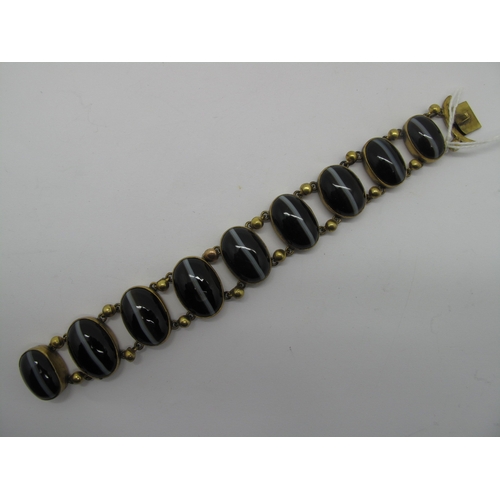 108 - A Victorian Gilt Metal and Hardstone Bracelet, of slightly graduated design, oval collet set (closed... 
