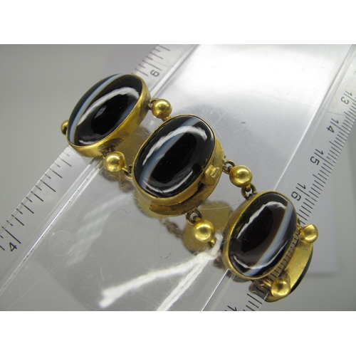 108 - A Victorian Gilt Metal and Hardstone Bracelet, of slightly graduated design, oval collet set (closed... 