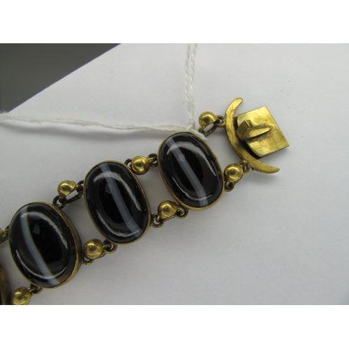 108 - A Victorian Gilt Metal and Hardstone Bracelet, of slightly graduated design, oval collet set (closed... 
