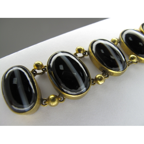 108 - A Victorian Gilt Metal and Hardstone Bracelet, of slightly graduated design, oval collet set (closed... 